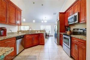 a large kitchen with wooden cabinets and appliances at Paradise Island in Carlton