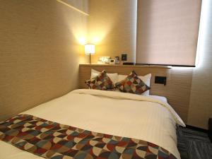 Postel nebo postele na pokoji v ubytování Astil Hotel Shinosaka Precious