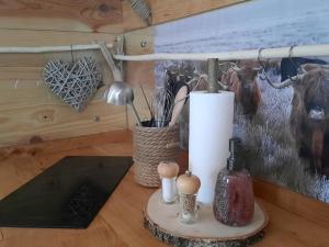 a table with a candle and a lamp and a painting at Le Domaine du Bodseu in Francorchamps