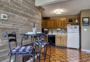 a kitchen with a table and chairs and a refrigerator at Renovated Chalet-pool-hot Tub-fireplace-sauna in Gatlinburg