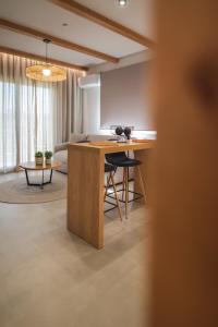 a kitchen with a wooden island in a room at Palaia Luxury Suite in Volos