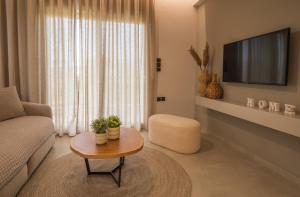 a living room with a couch and a coffee table at Palaia Luxury Suite in Volos