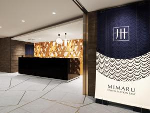 a lobby of a hotel with a sign on the wall at MIMARU Tokyo STATION EAST in Tokyo