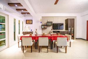 a dining room with a red table and chairs at Sunny Homestay in Jian