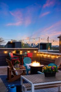 a patio with chairs and a fire pit on a rooftop at Dolly PartyOn - Downtown Views - Rooftop - Groups in Nashville