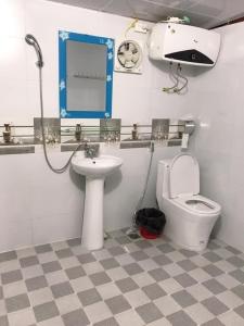 a bathroom with a toilet and a sink at J'House in Sa Pa