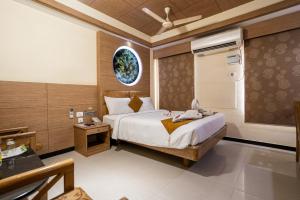 a bedroom with a large bed in a room at Sree Bharani Hotels in Tirunelveli +36 photos