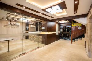 a lobby of a restaurant with a glass door at Sree Bharani Hotels in Tirunelveli