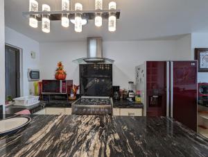 a kitchen with a stove and a refrigerator at Villa Aurora Beautiful Beachfront Apartment in Cancún