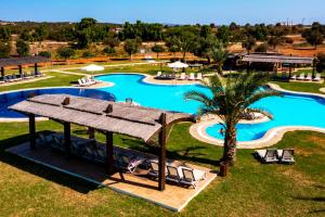 an overhead view of a pool at a resort at Exclusive Apartments in Thalassa Beach Resort in Vokolidha