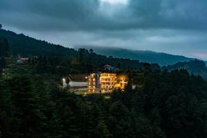 a large building in the middle of a mountain at Hotel Atithi Satkar in Nagarkot