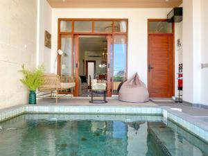 a swimming pool in front of a house at Siji Nayan Vacation Home in Yogyakarta