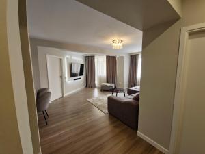 a living room with a couch and a chair at Royal Trip Luxury Apartment Sinaia in Sinaia