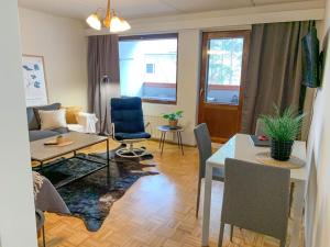 a living room with a table and a dining room at 2BR Apartment KA22, free parkig, sauna, big balcony in Oulu