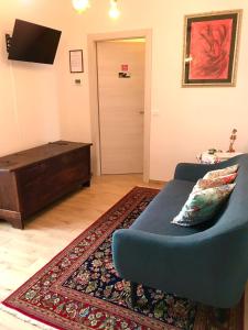 a living room with a blue couch and a door at ANTICA FILANDA Lattes in Cuneo