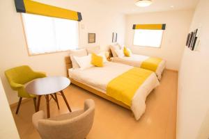 Ένα ή περισσότερα κρεβάτια σε δωμάτιο στο 沖縄県屈指のリゾート地恩納村にある一軒家貸切！広々テラスでBBQを楽しみながら最高のバカンスを！