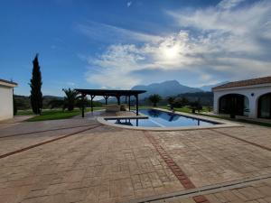 a patio with a pavilion and a swimming pool at Villa con piscina privada - Benimarraig in Benissa