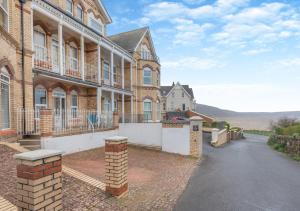 a large brick building with a road in front of it at 1 Dolphin Court in Woolacombe