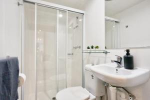 a bathroom with a shower and a sink and a toilet at Vibrant 3 Bedroom House Darlinghurst 2 E-Bikes Included in Sydney