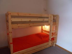 a wooden bunk bed in a room at Majestic Apartment in Meribel Mottaret close to Skiing in Méribel
