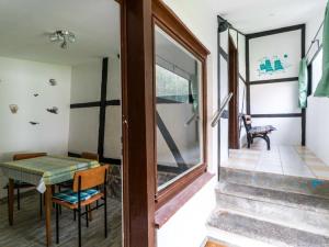 a room with a table and chairs and a glass door at Lake View Apartment in Klein Pravtshagen with Garden in Klein Pravtshagen