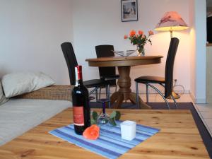 a bottle of wine sitting on top of a table at Cozy Apartment in Zingst Germany near Beach in Zingst