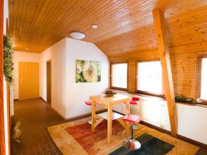 a room with a wooden ceiling and a table and chairs at Large Apartment in Urberg in the black forest in Urberg