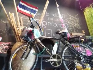 two bikes chained to a wall with a flag at Goodnighthostel@Trang in Trang