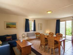 a living room with a table and a couch at Appealing apartment in Vezac with swimming pool in Beynac-et-Cazenac