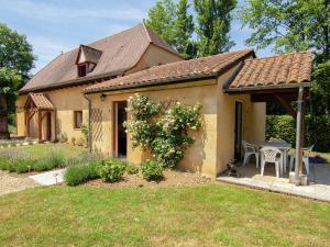 a small house with a gazebo in a yard at Appealing apartment in Vezac with swimming pool in Beynac-et-Cazenac