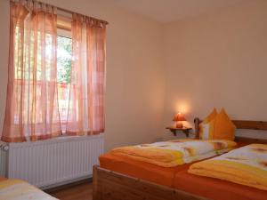 1 Schlafzimmer mit 2 Einzelbetten und einem Fenster in der Unterkunft Spacious Apartment in Wieck auf dem DarB in Wieck