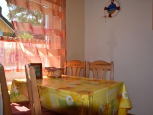 a table with a yellow table cloth on top of it at Spacious Apartment in Wieck auf dem DarB in Wieck