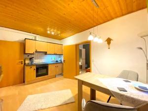a kitchen and dining room with a wooden ceiling at Comfortable apartment in Zenting in Lower Bavaria in Zenting