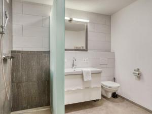 a bathroom with a sink and a toilet at Chalet in Neukirchen with Mountain Views in Rosenthal +23 photos