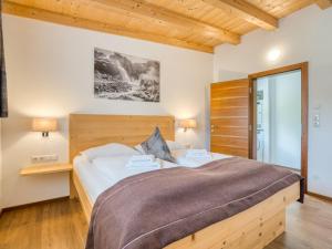 a bedroom with a large bed with a wooden headboard at Apartment building Ferien, Neukirchen in Rosenthal
