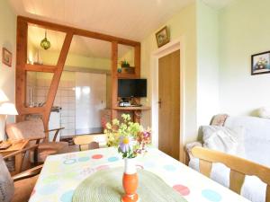 a vase of flowers on a table in a living room at Lovely Farmhouse in K hlungsborn near sea in Kühlungsborn