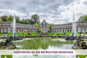 a large building with a fountain in front of a pond at Apartment Wahnfried No3 - citynah wohnen mit Küche und Duschbad, Parkplatz, 300m zur Fussgängerzone in Bayreuth