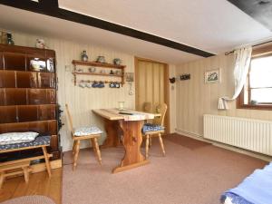 a room with a wooden table and two chairs at Attractive holiday home in Ahlbeck with terrace in Ahlbeck