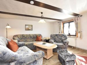 a living room with couches and a table at Attractive holiday home in Ahlbeck with terrace in Ahlbeck