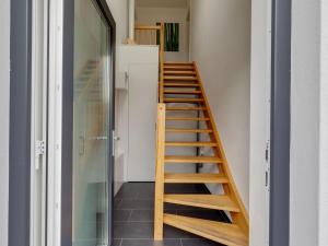 a staircase in a room with a glass door at Pleasant Holiday Home in Zierow near Sea in Zierow