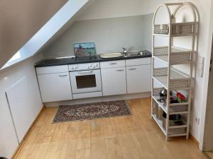 uma cozinha com um lavatório e um fogão em Schönes Dachapartment (2 Schlafzimmer) em Gütersloh