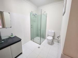 a bathroom with a glass shower and a toilet at Unit 59 Seafront Estate in Jurien Bay +9 photos