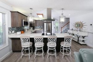 a kitchen with a island with bar stools at Heavens Edge 2016 in Gatlinburg