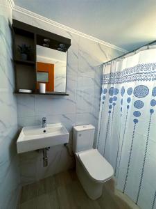 ein weißes Bad mit einem Waschbecken und einem WC in der Unterkunft My Lemnos Studios - Studio 1 in Repanídhion