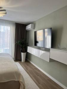 a bedroom with a flat screen tv on the wall at Apartmán Artemis in Košice