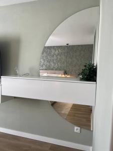 a bathroom with a mirror and a sink at Apartmán Artemis in Košice