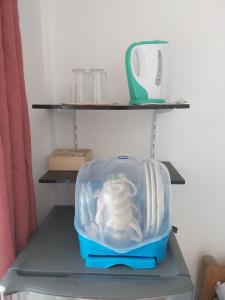 a plastic container sitting on a shelf in a refrigerator at Olivers Binucot-Beach-House in Ferrol