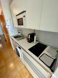 a kitchen with a sink and a washing machine at Casa Las Torres 209 in Costa de Antigua