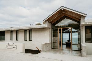 a building with a large entrance with glass doors at Pure Sea Boutique Lodge in Gansbaai