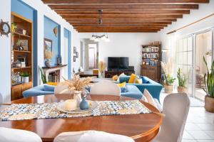 a living room with a table and blue furniture at Villa peristeri in Alinda
